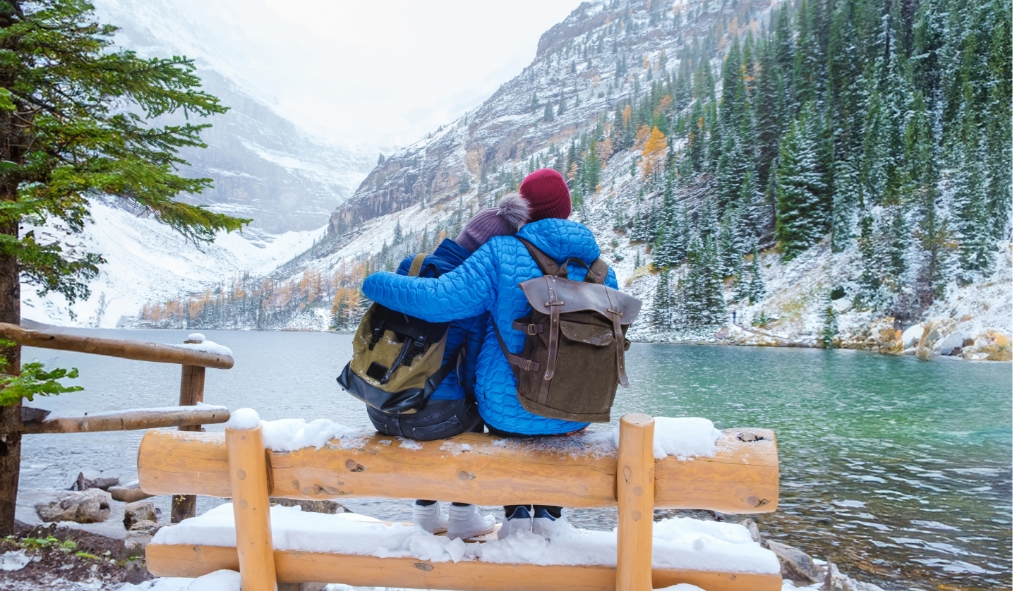 british columbia canada couple looking onto snowy lake in rocky mountains