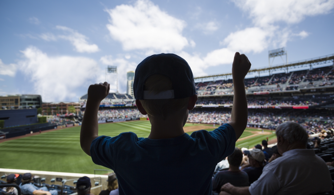Child standing and cheering at a baseball game