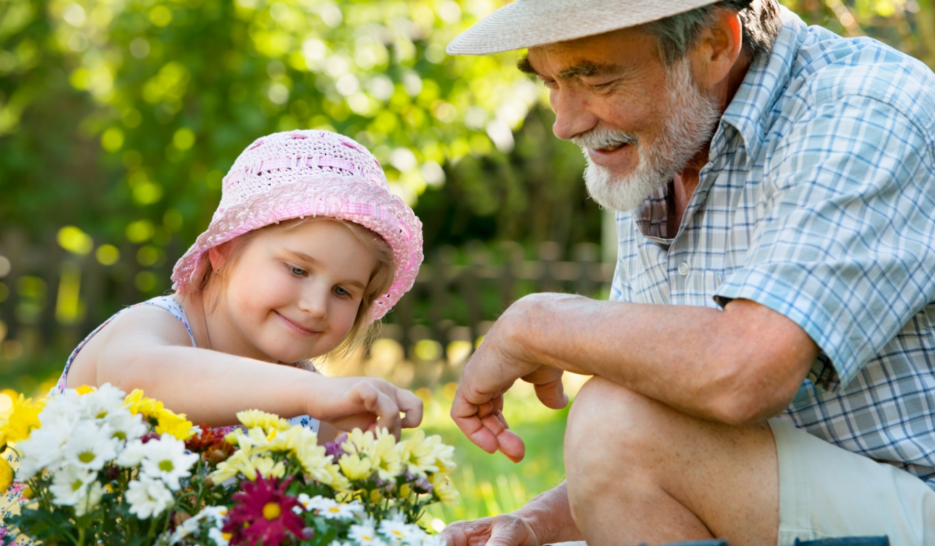 grandfather with his granddaughter in the garden