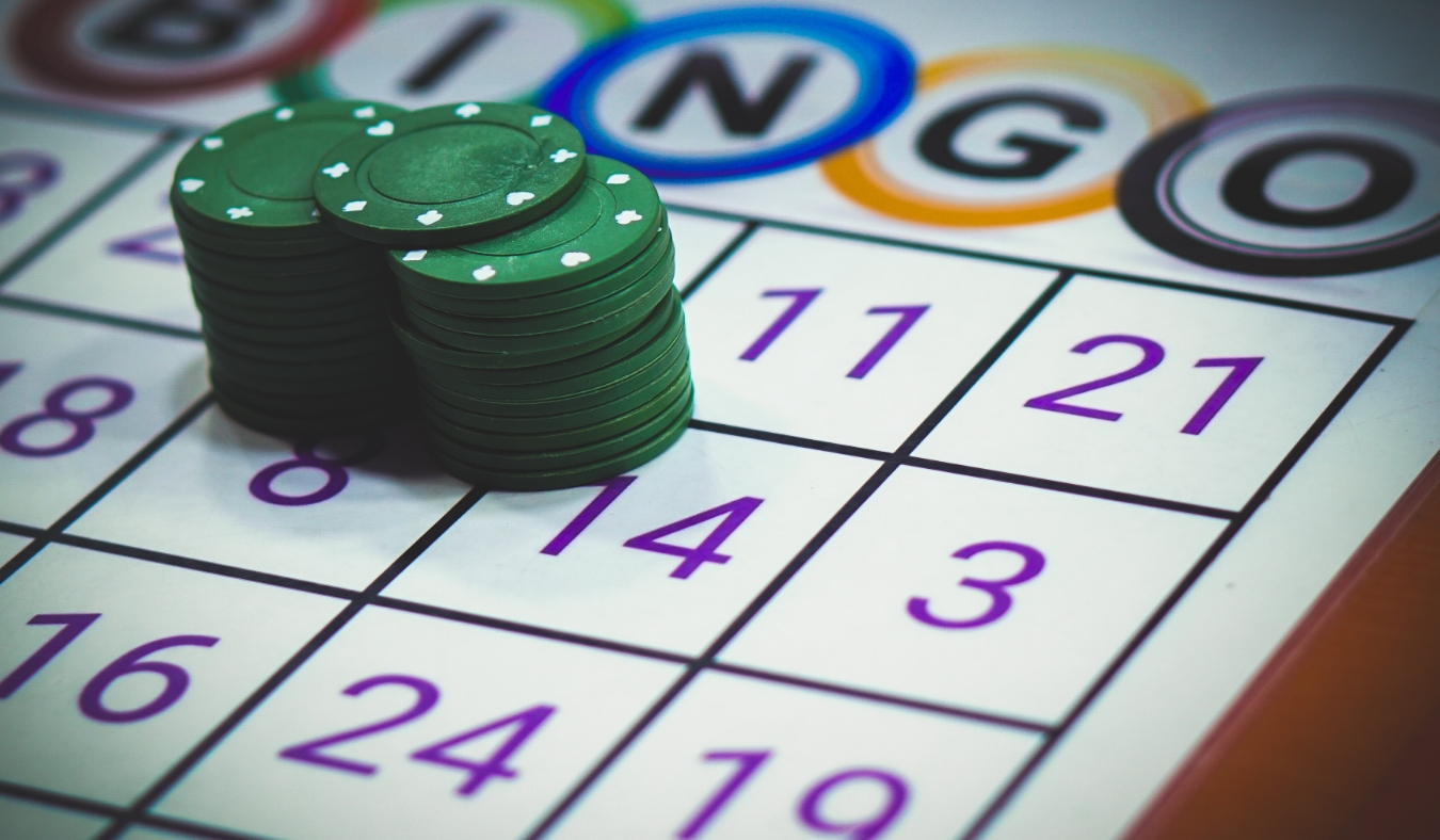 green bingo chips on bingo playing card