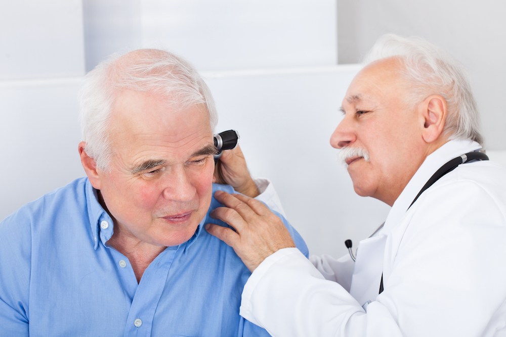 older gentleman in hearing clinic for diagnostic audiologic evaluation optimized