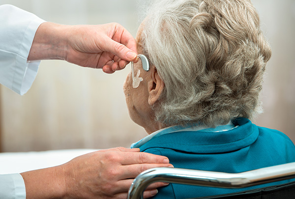 senior getting new hearing aids for hearing loss