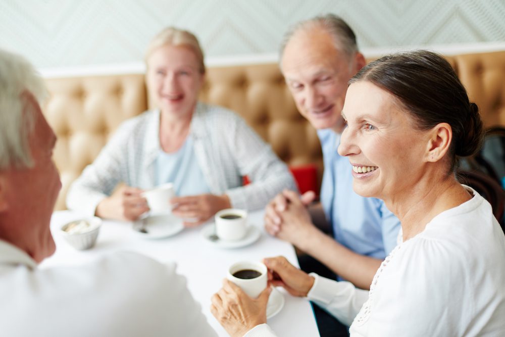 senior couples gathered for coffee in a local shop