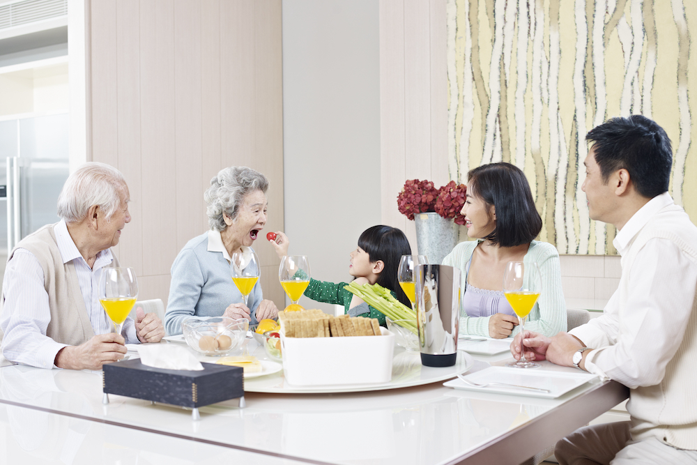 multi generational family gathered for dinner in bright dining room