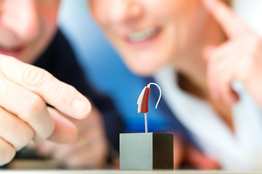 a premium hearing aid on a display stand