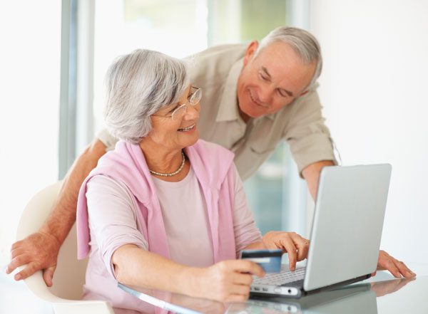 couple searching for a hearing provider on their laptop