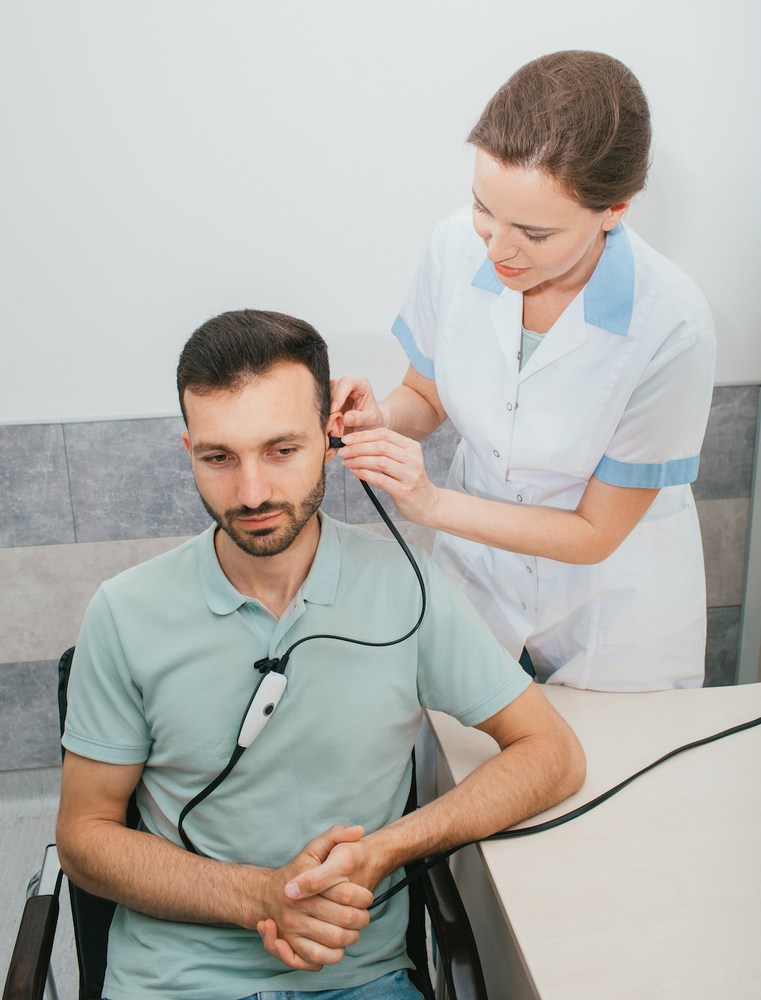 hearing specialist administering a professional hearing test