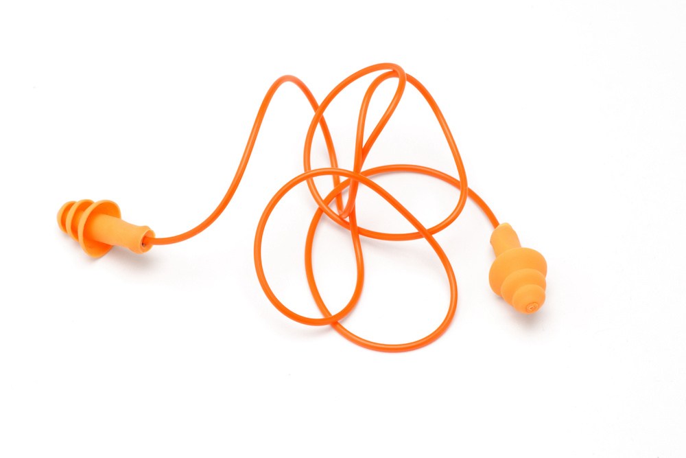 a pair of corded disposable orange earplugs