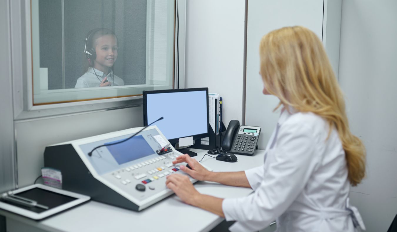 hearing test young girl in booth