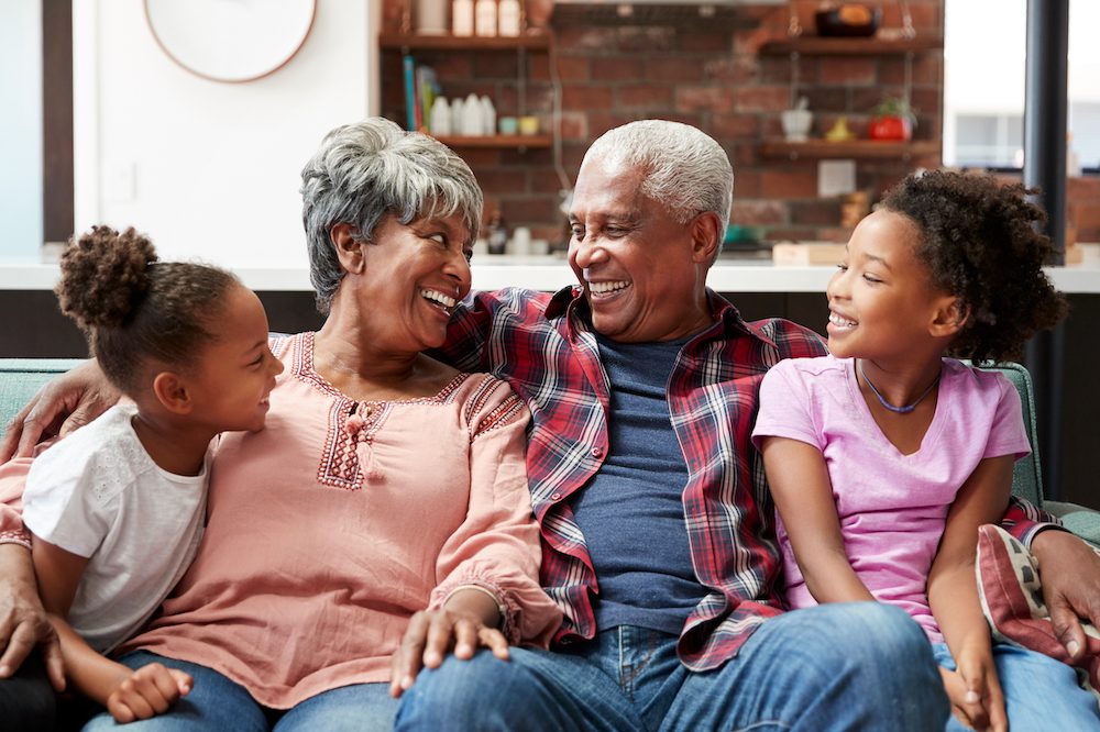 family sitting on couch in their home