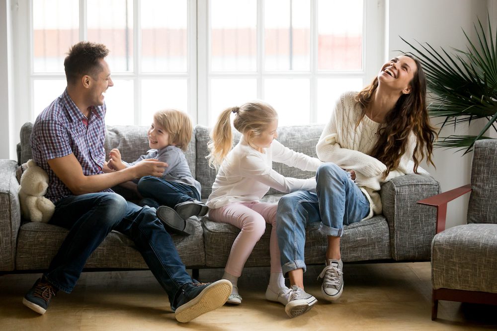 a family hanging out at home on couch