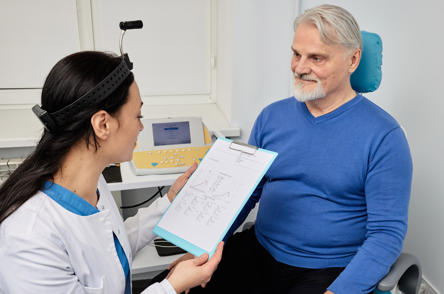 audiologist doing consultation for senior man patient