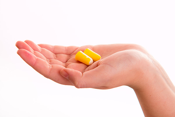 Hand Holding Earplugs
