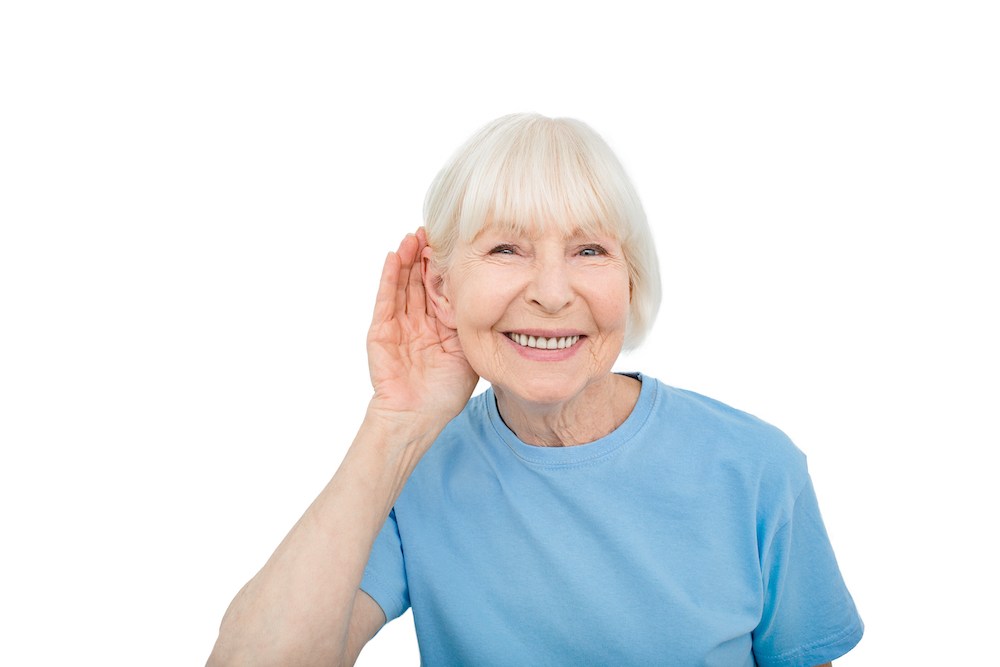 senior patient holding hand to ear