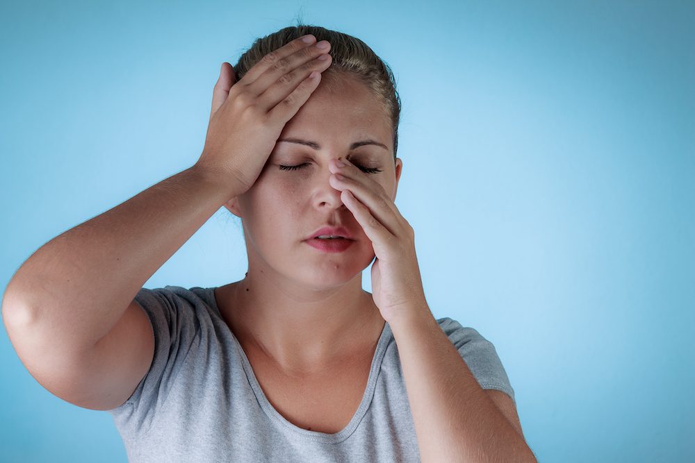 woman with head and nose pain