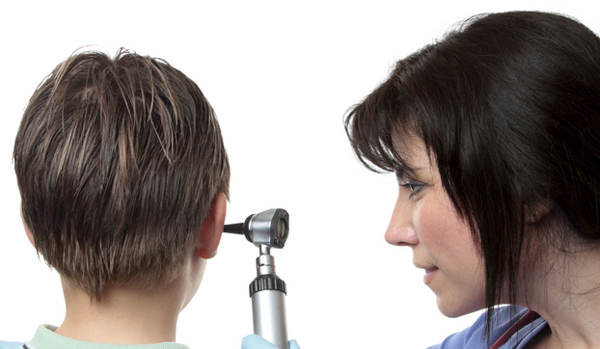 a pediatric ear doctor examining a child's ear