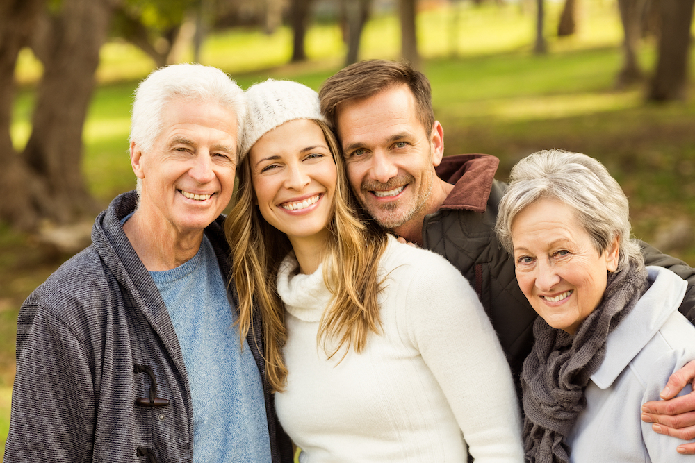 parents and children smiling outdoors 