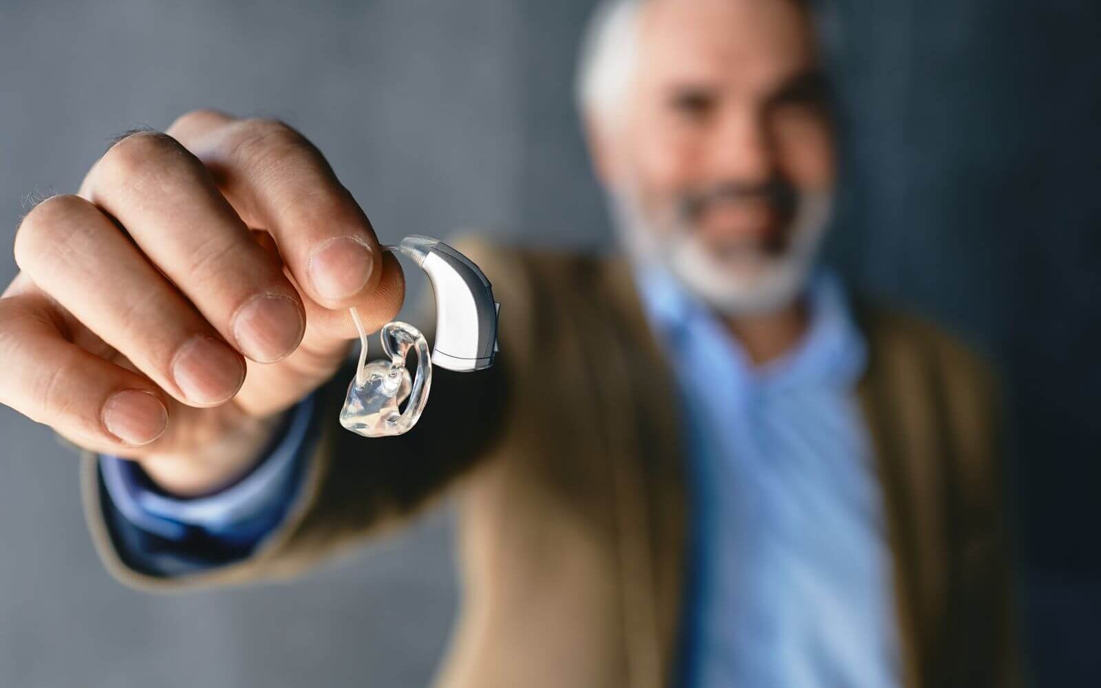man holding hearing aid
