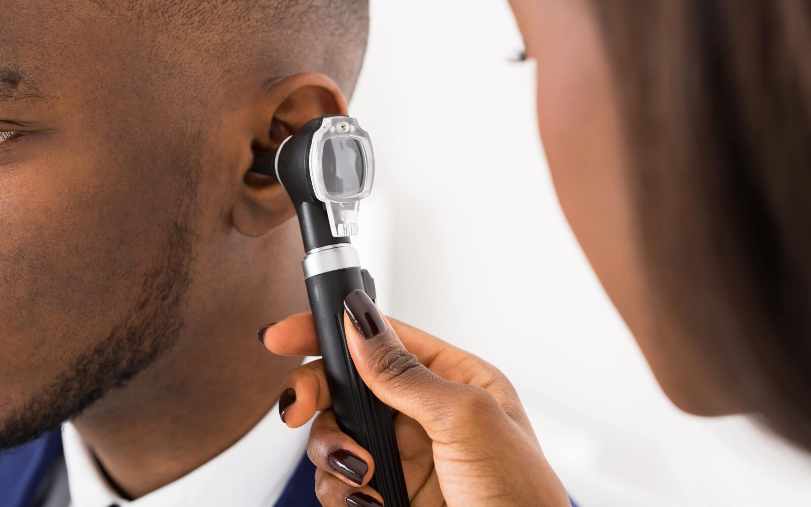 audiologist conducting otoscopy exam