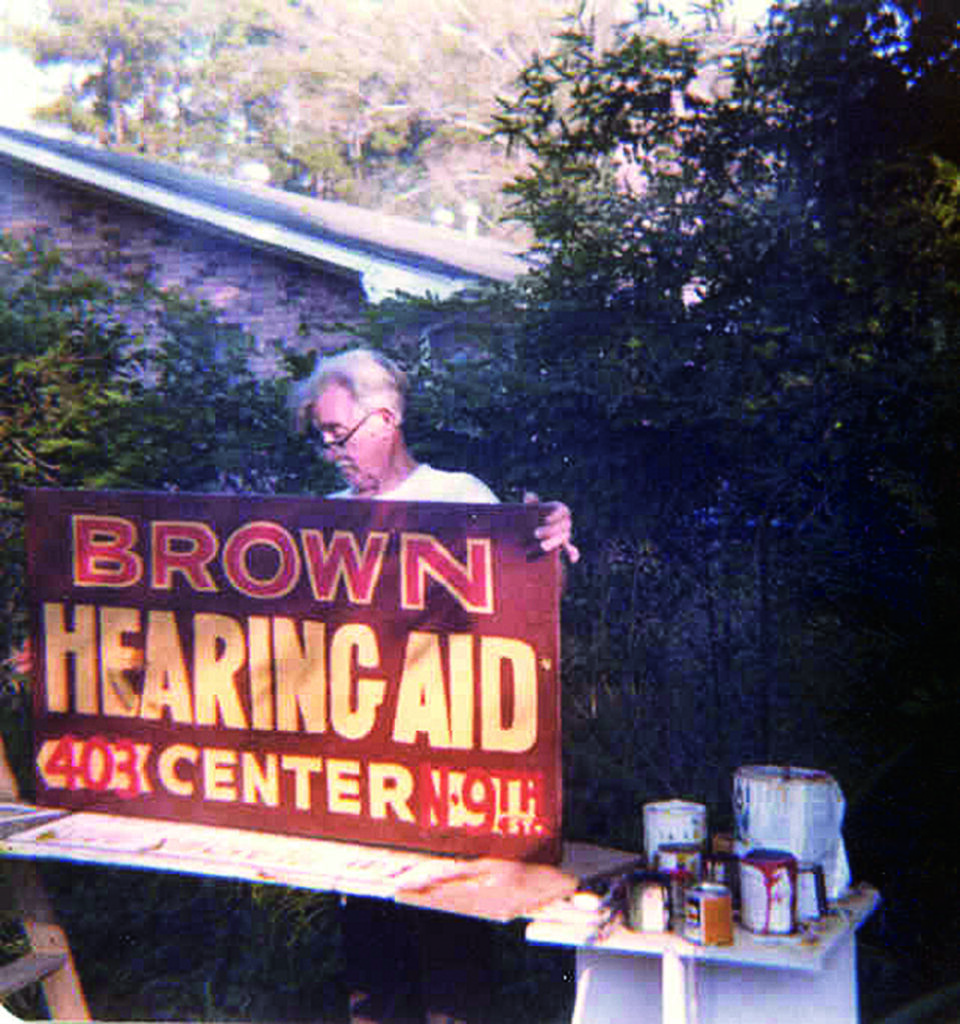 *Lee Brown’s father painting one of our early office signs circa 1966.