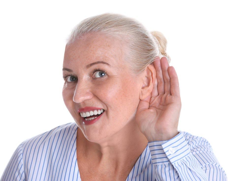 smiling hearing loss patient struggling to hear properly