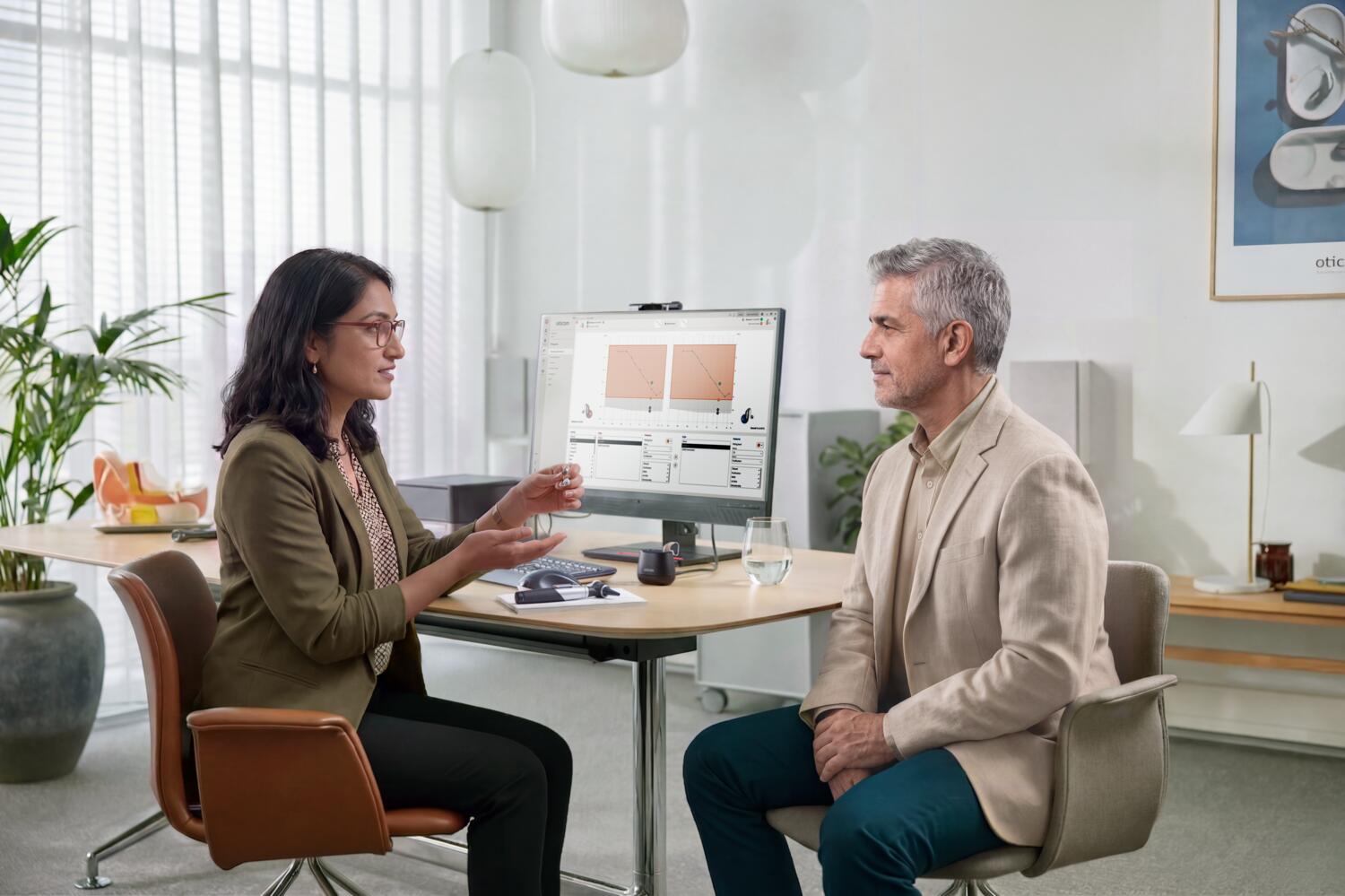 oticon reveal lifestyle counselling hearing aid in provider hand