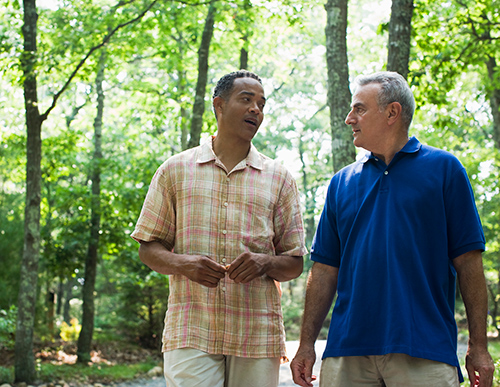 Picture of two guys talking to each other | What to do Do When A Friend Really Needs To Get Their Hearing Tested  title=
