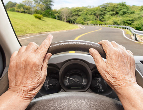 Picture of senior driver behind the wheel | How Does Hearing Loss Affect Your Driving Skills?
