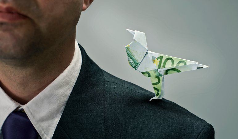 Man with mild hearing loss dressed for work with little bird made of money whispering in his ear.