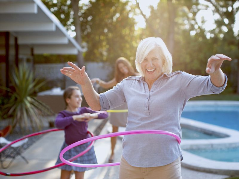 Woman not letting hearing loss and use of hearing aids stop her from feeling young and playing with her grandkids.