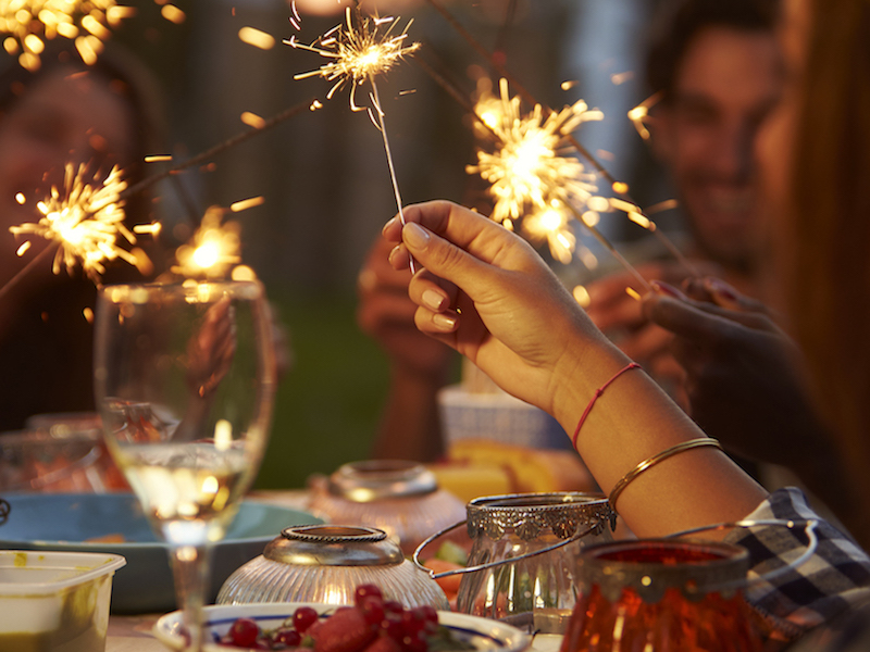 Family enjoying independence day celebration oblivious to the risk of hearing loss from fireworks.