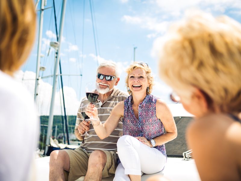 Couple wearing hearing aids with glasses enjoy a vacation.