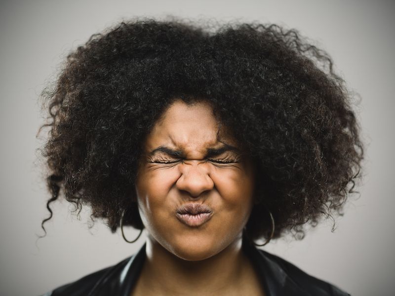 Woman suffering from ringing in her ears.