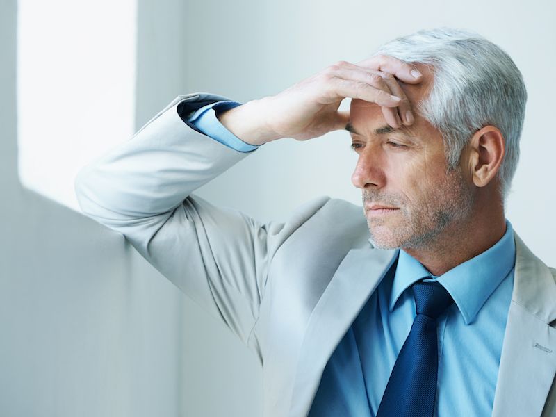Man suffering from hearing loss considering the side effects of losing his hearing.