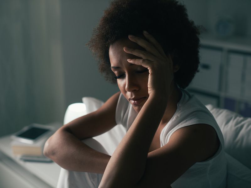 Woman who is having trouble sleeping because she has tinnitus.
