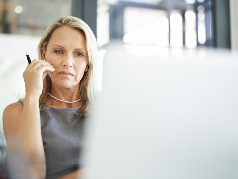 Woman having difficulty concentrating because of hearing loss.