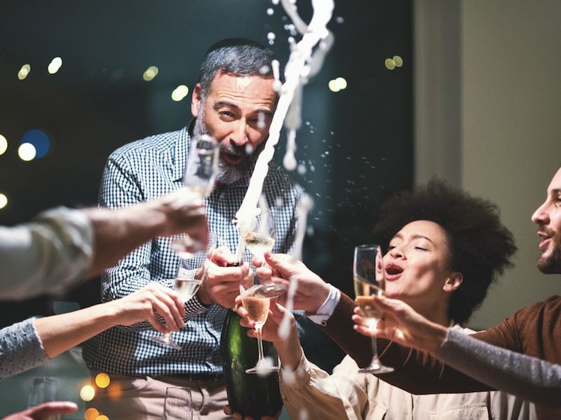 Man able to enjoy lively party because he's using two hearing aids instead of one.