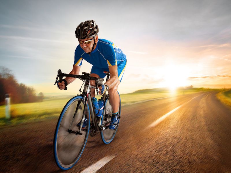 Man wearing hearing aids while biking.