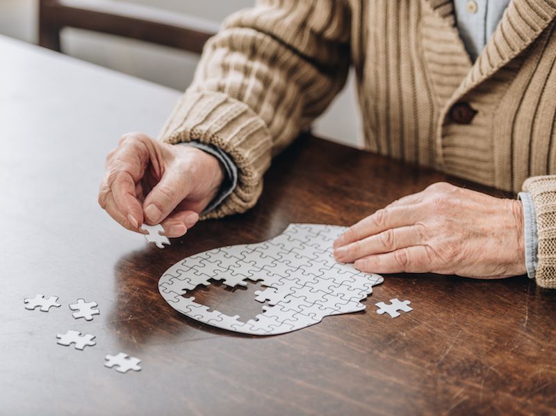 Woman with hearing loss gets hearing aid to slow down her dementia and completes a puzzle.