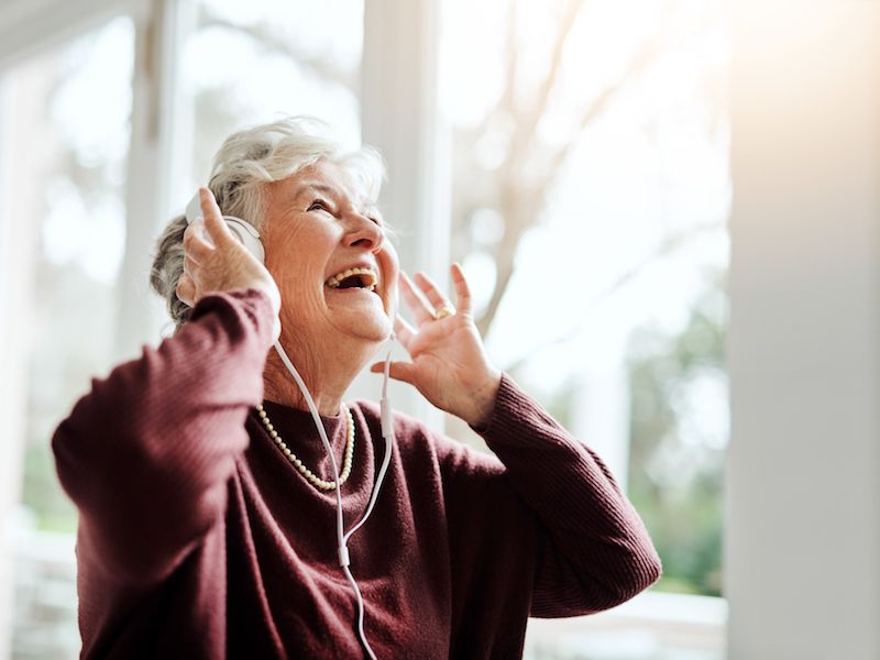 Woman enjoying music with headphones but protecting her hearing.