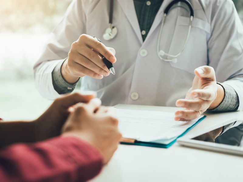 Doctor speaks with patient about medical conditions related to hearing loss and tinnitus.