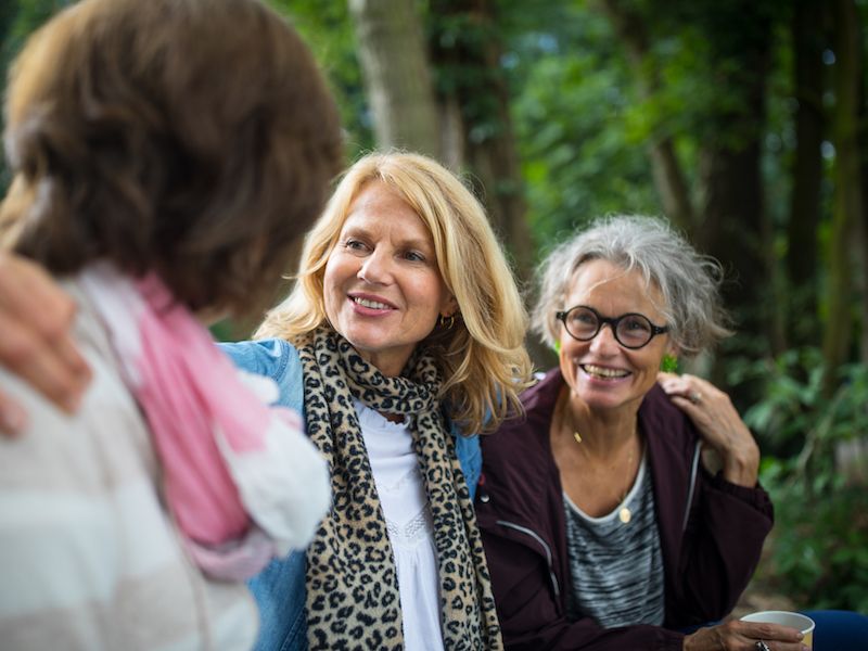 Woman wearing hearing aids enjoys a hike with friends.