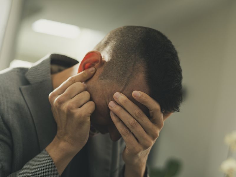Man suffering from ringing in the ears reads about new research into the causes of tinnitus.