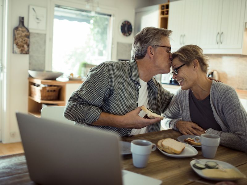 Couple in denial about their hearing loss laugh over misunderstanding.