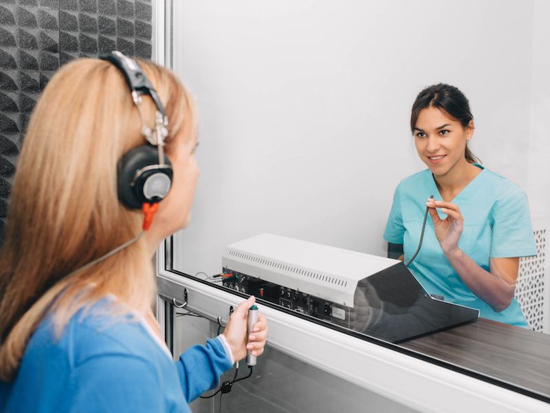 Woman getting her hearing test to see if she has hearing loss.