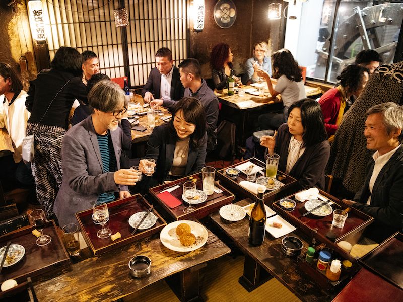 Man can't hear in a crowded restaurant.