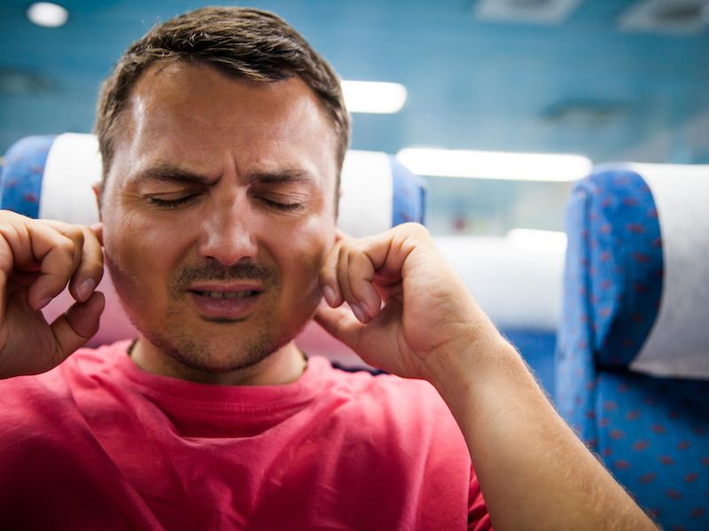 Man making his ears pop on an airplane.