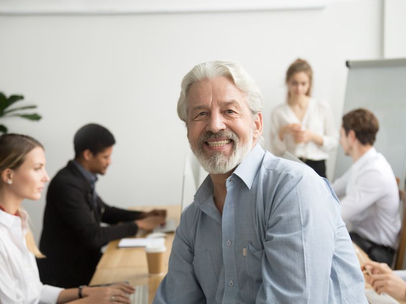 Man feeling more confident about wearing his hearing aids at work now that stigma around hearing aids is waning.