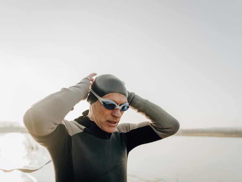 Man holding blocked ear after swimming.