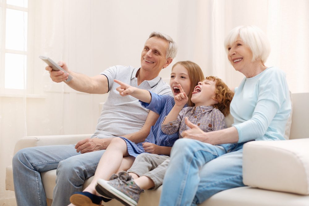 family watching tv on the couch